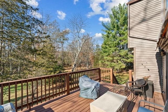 wooden terrace featuring a grill