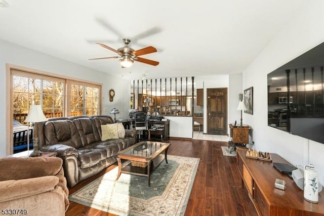 living room with ceiling fan and wood-type flooring