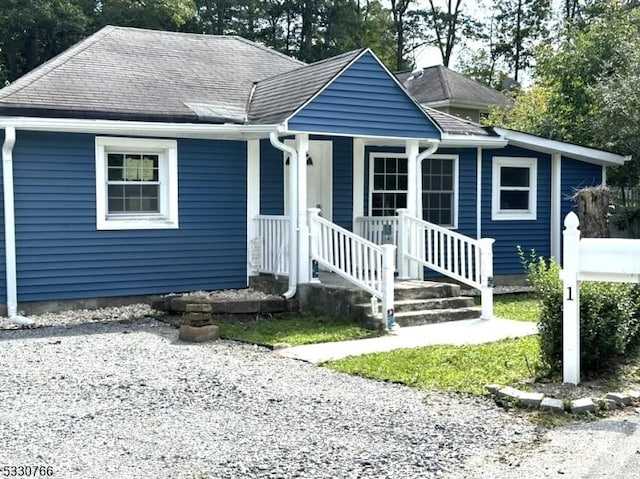 bungalow-style home featuring a shingled roof