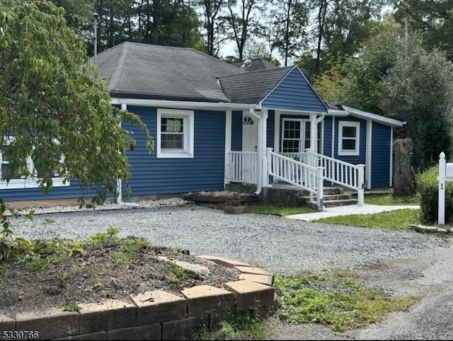 view of front of house with roof with shingles