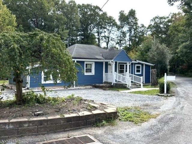 ranch-style home with gravel driveway