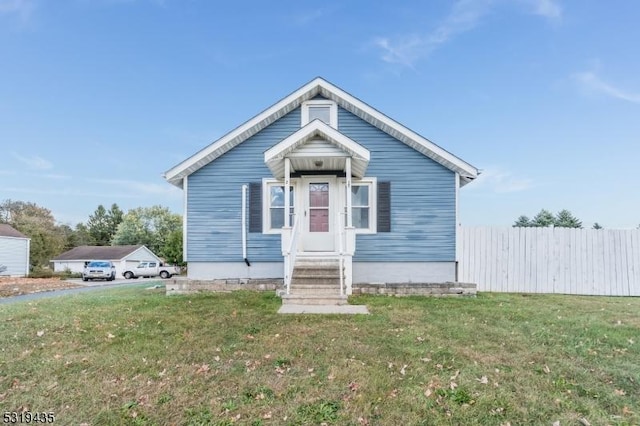 bungalow-style home with a front lawn