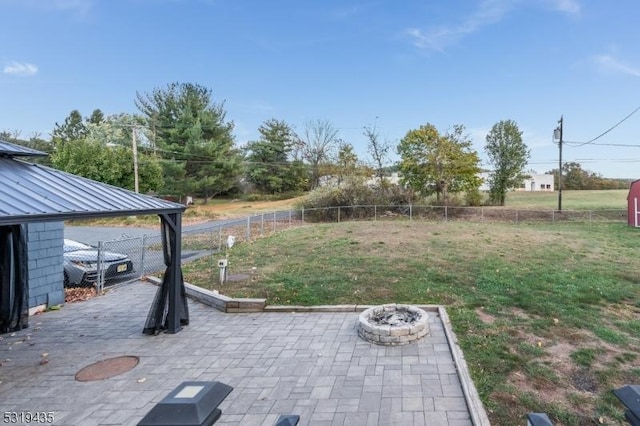 view of yard with a fire pit and a patio