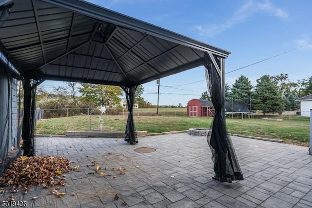 view of patio / terrace with a gazebo, a storage shed, and a trampoline