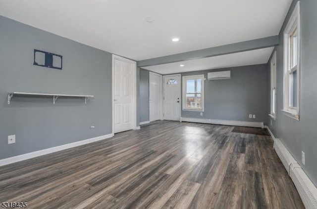 unfurnished living room with a wall unit AC, a baseboard radiator, and dark hardwood / wood-style floors