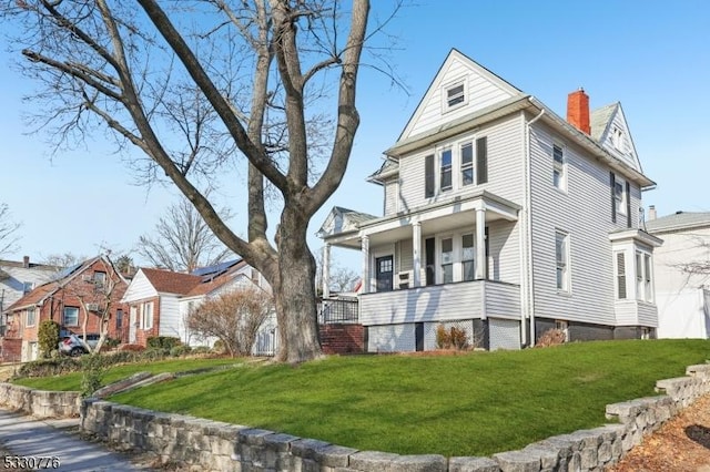 view of side of home with a yard