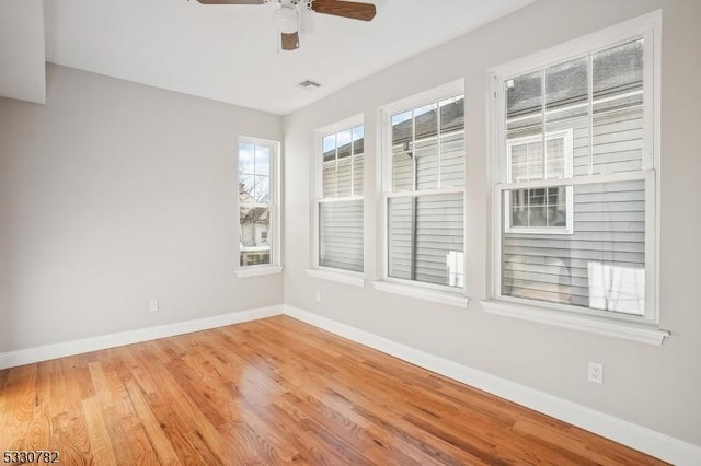 empty room featuring ceiling fan and light wood-type flooring