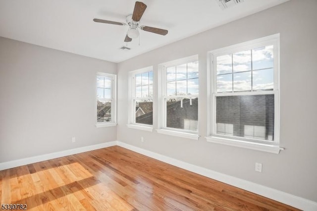 spare room featuring ceiling fan and hardwood / wood-style flooring