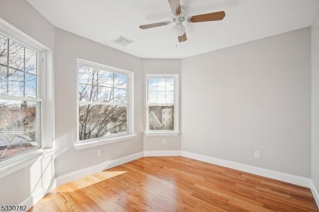 unfurnished room with light wood-type flooring and ceiling fan