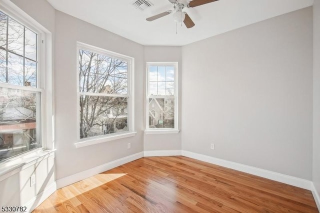 unfurnished room with ceiling fan and hardwood / wood-style floors