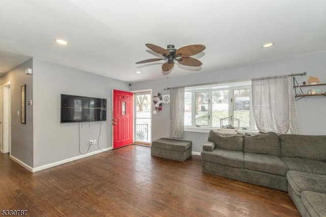 unfurnished living room with ceiling fan and dark wood-type flooring