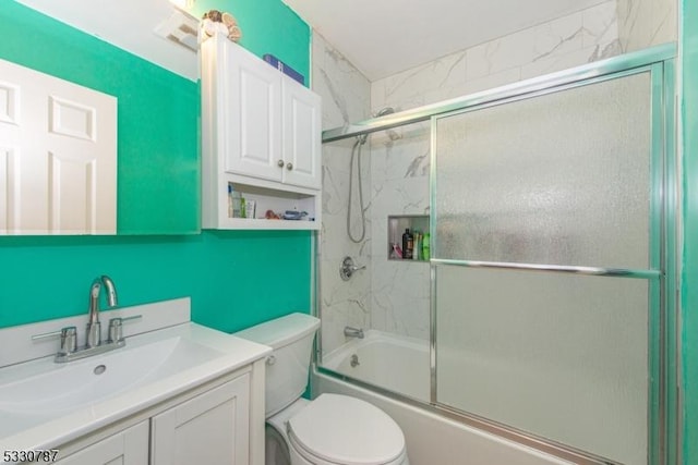 full bathroom with vanity, toilet, and bath / shower combo with glass door