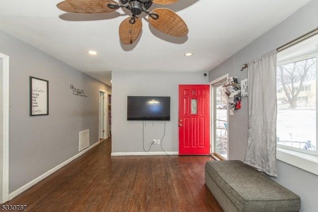 foyer entrance with ceiling fan, dark wood-type flooring, and a healthy amount of sunlight