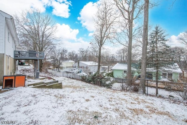 yard layered in snow featuring a wooden deck