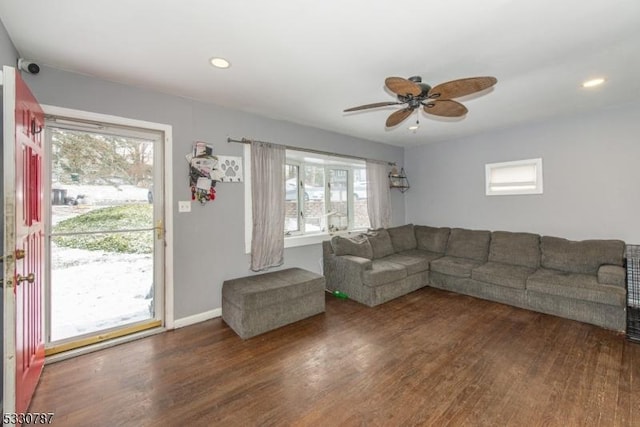 unfurnished living room featuring a wealth of natural light, dark hardwood / wood-style flooring, and ceiling fan