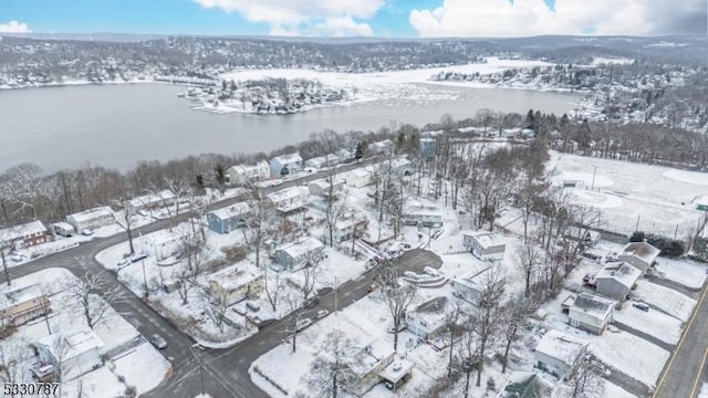 snowy aerial view with a water view