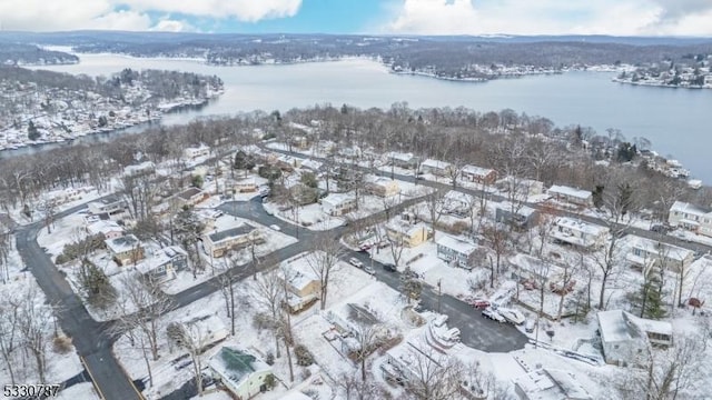 snowy aerial view featuring a water view