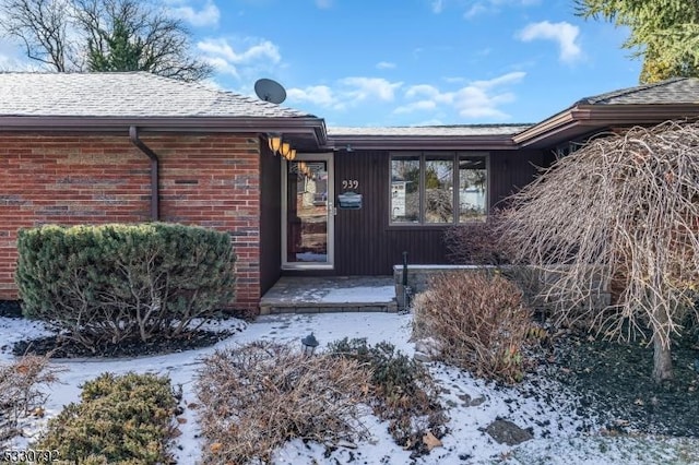 view of snow covered property entrance