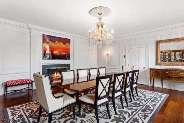 dining room with dark hardwood / wood-style flooring and an inviting chandelier