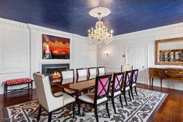 dining room with dark hardwood / wood-style floors and an inviting chandelier