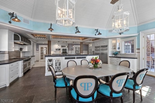 dining space featuring beamed ceiling, a chandelier, and high vaulted ceiling