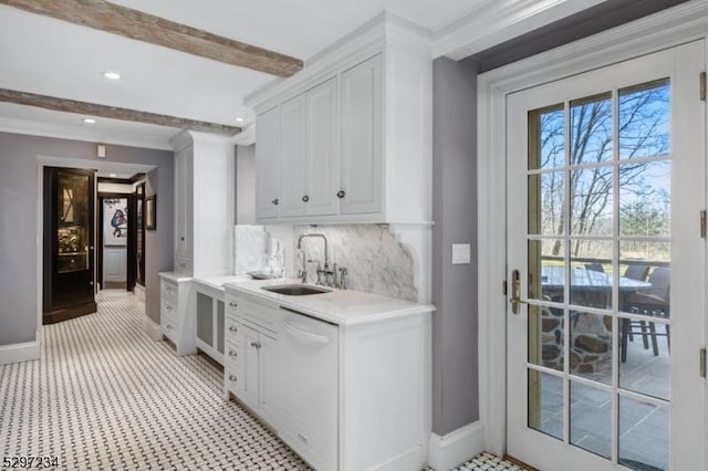 bar with tasteful backsplash, sink, beamed ceiling, dishwasher, and white cabinetry