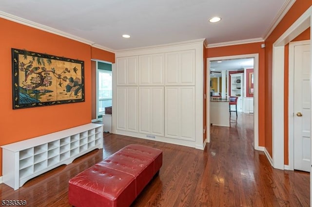 living area featuring dark hardwood / wood-style flooring, built in features, and ornamental molding