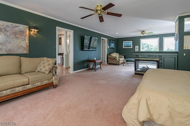 bedroom with carpet floors, a high end fireplace, crown molding, and ceiling fan