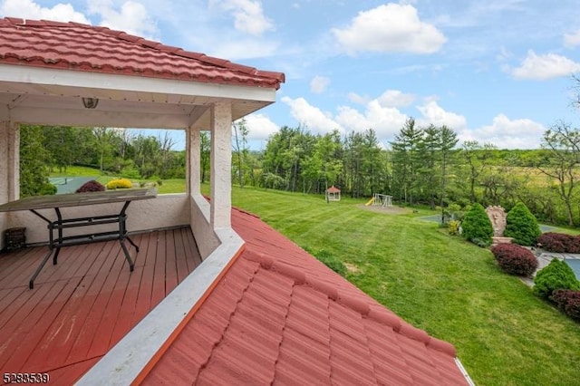 wooden terrace with a lawn