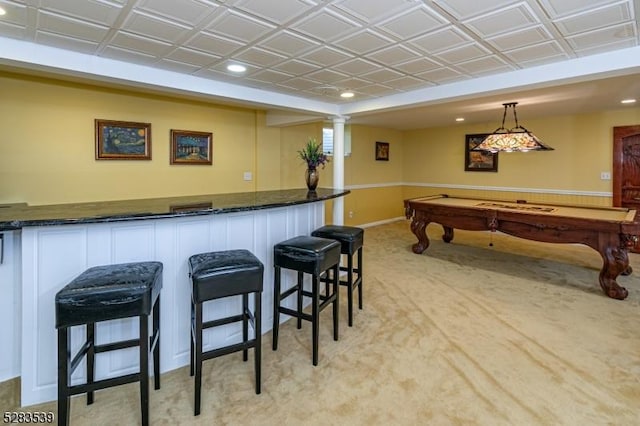 bar with light colored carpet, hanging light fixtures, and pool table