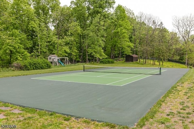 view of sport court with a playground and basketball court