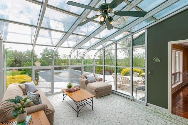 sunroom featuring ceiling fan