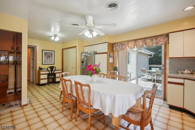 dining space featuring light tile patterned floors and ceiling fan