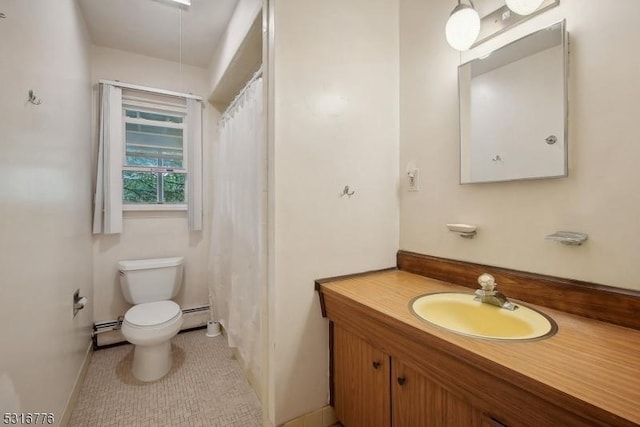 bathroom featuring tile patterned floors, vanity, toilet, and a baseboard radiator