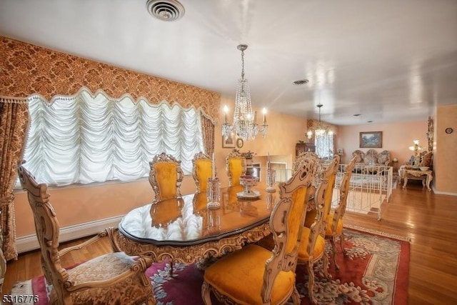 dining space with hardwood / wood-style floors