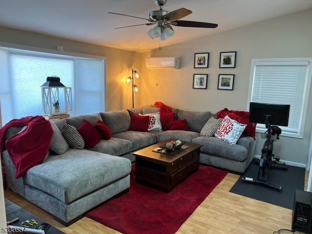 living room featuring lofted ceiling, a wall mounted air conditioner, hardwood / wood-style flooring, and ceiling fan