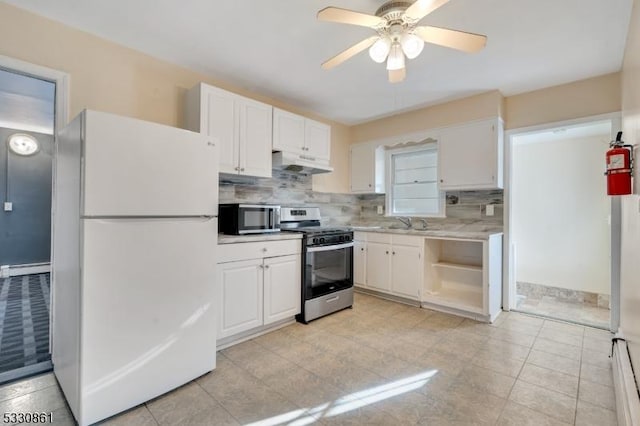 kitchen featuring white cabinets, white fridge, and stainless steel range oven