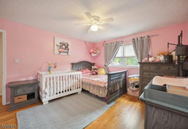 bedroom featuring hardwood / wood-style floors and ceiling fan