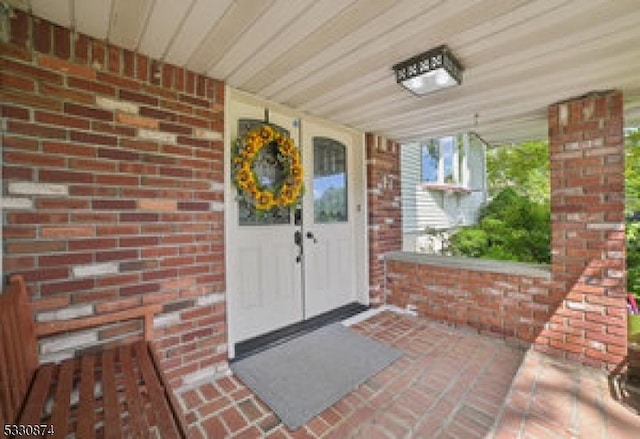 doorway to property featuring a porch