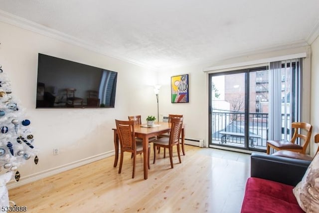 dining space with wood-type flooring, baseboard heating, and ornamental molding