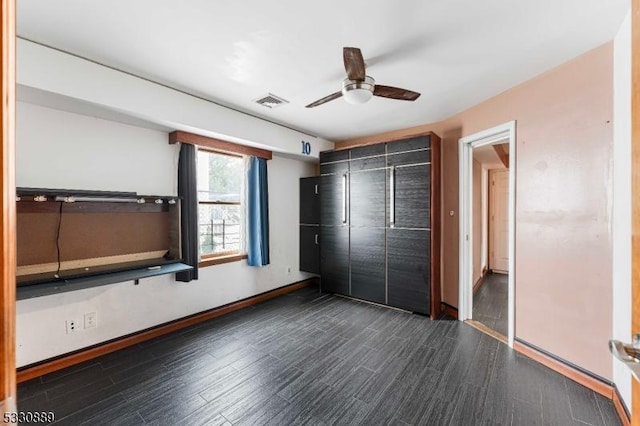 unfurnished bedroom featuring dark hardwood / wood-style floors, a closet, and ceiling fan