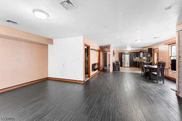 unfurnished living room featuring dark hardwood / wood-style floors