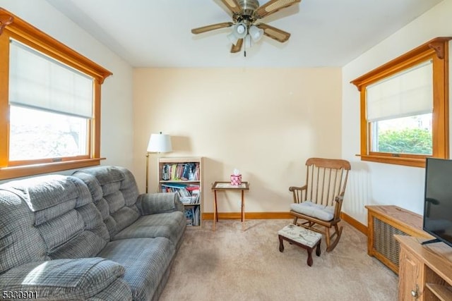 carpeted living room featuring ceiling fan