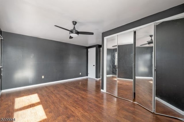 unfurnished bedroom featuring wood-type flooring, a closet, and ceiling fan