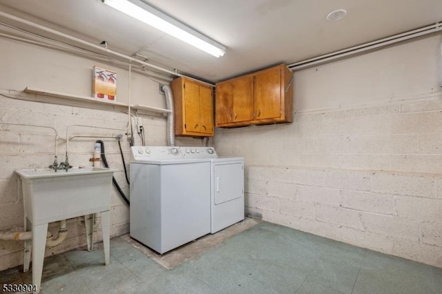 washroom featuring cabinets, separate washer and dryer, and sink