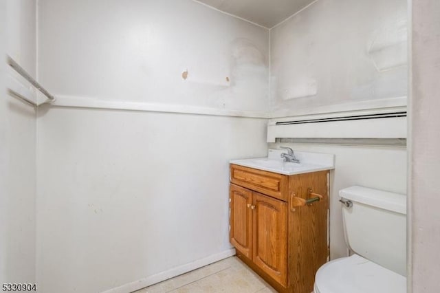 bathroom with toilet, vanity, and tile patterned floors