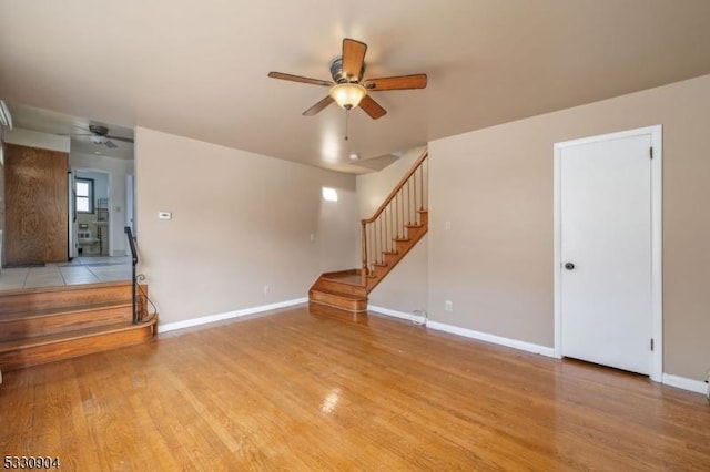 unfurnished living room featuring ceiling fan and light wood-type flooring