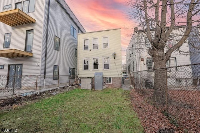 back house at dusk with a yard