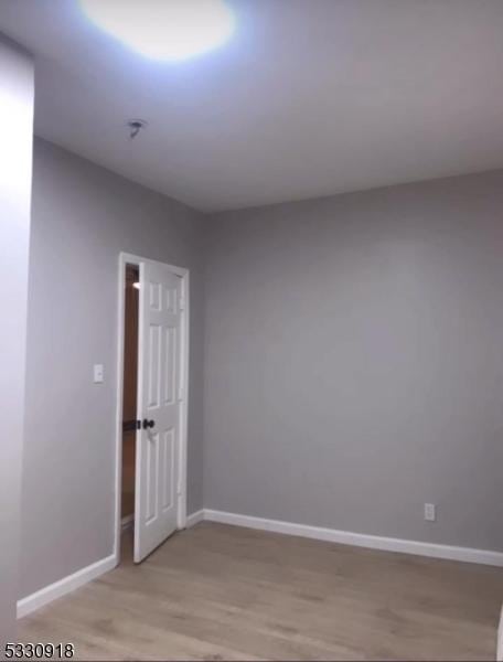 empty room with light hardwood / wood-style floors