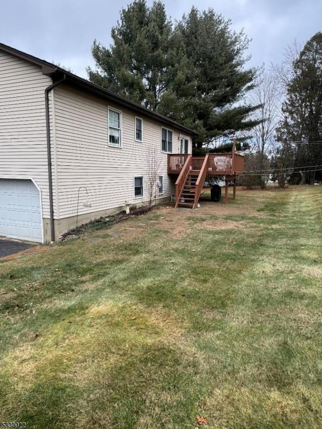 exterior space featuring a garage and a wooden deck